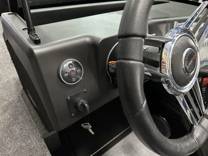 Slide: The Image of 2025 Alumacraft Competitor 175X Sport dashboard with steering wheel and ignition key. - 13