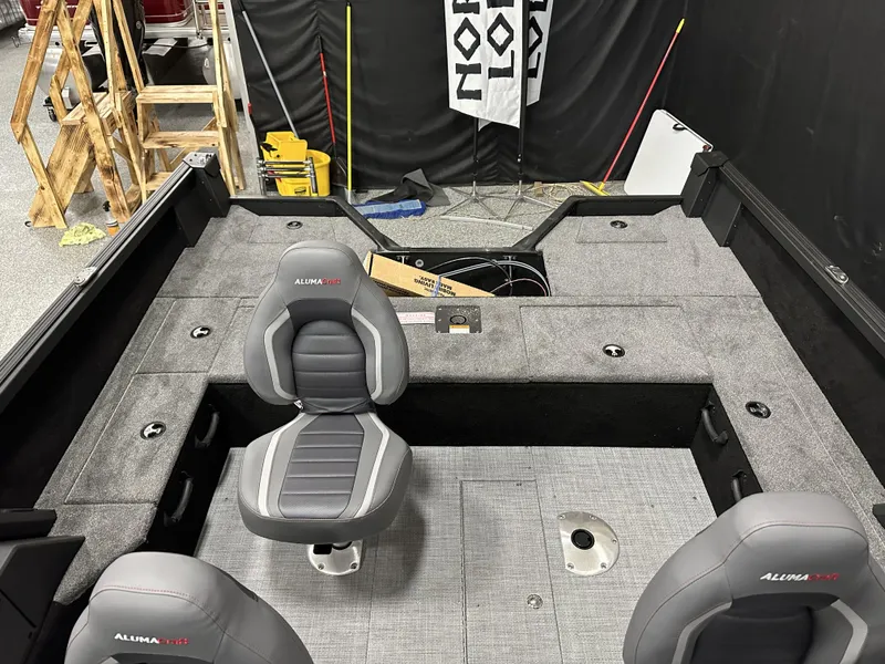 Slide: The Image of 2025 Alumacraft Competitor 175X Sport interior with gray seating and spacious deck layout. - 14
