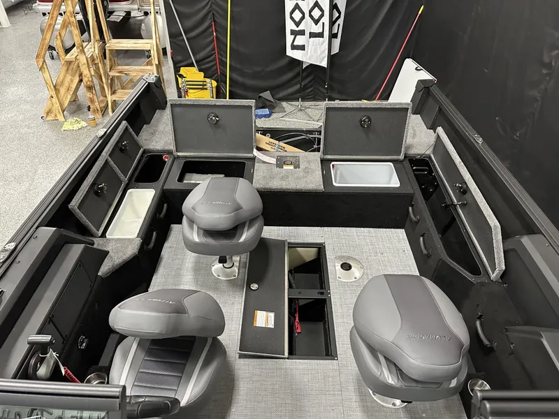 Slide: The Image of 2025 Alumacraft Competitor 175X Sport interior with seating and storage compartments. - 16