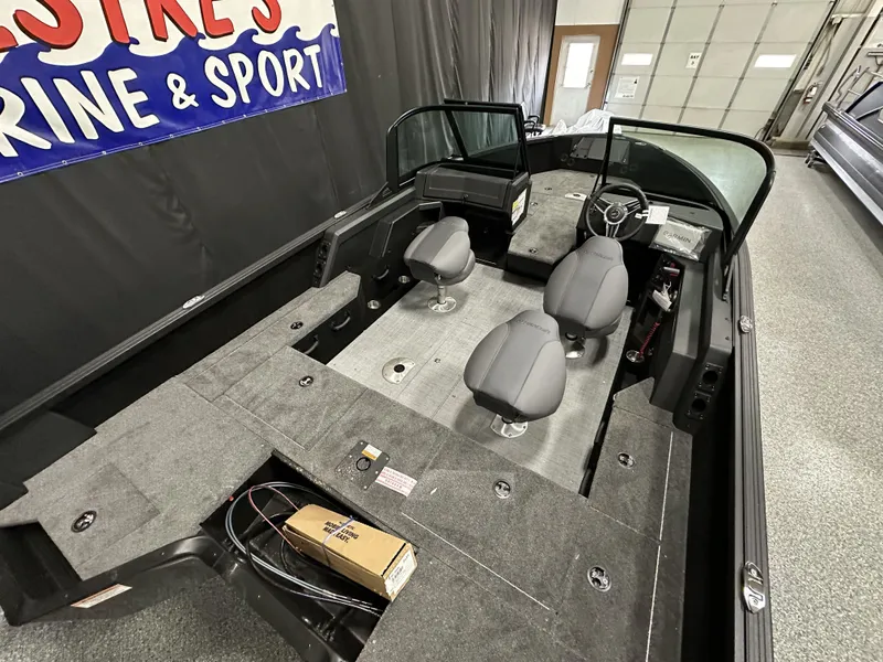Slide: The Image of 2025 Alumacraft Competitor 175X Sport interior with seating and storage compartments. - 18