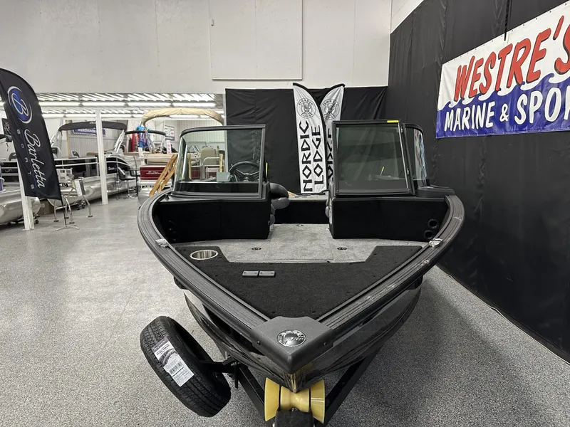 Slide: The Image of 2025 Alumacraft Competitor 175X Sport boat displayed indoors at a marine showroom. - 4