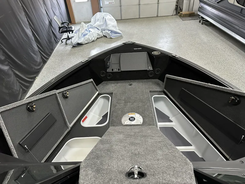 Slide: The Image of 2025 Alumacraft Competitor 175X Sport boat interior with open storage compartments. - 8
