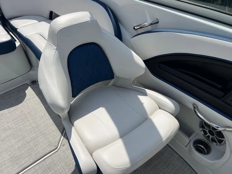 Slide: The Image of 2021 Crownline 255 SS boat interior with white and blue seating. - 10