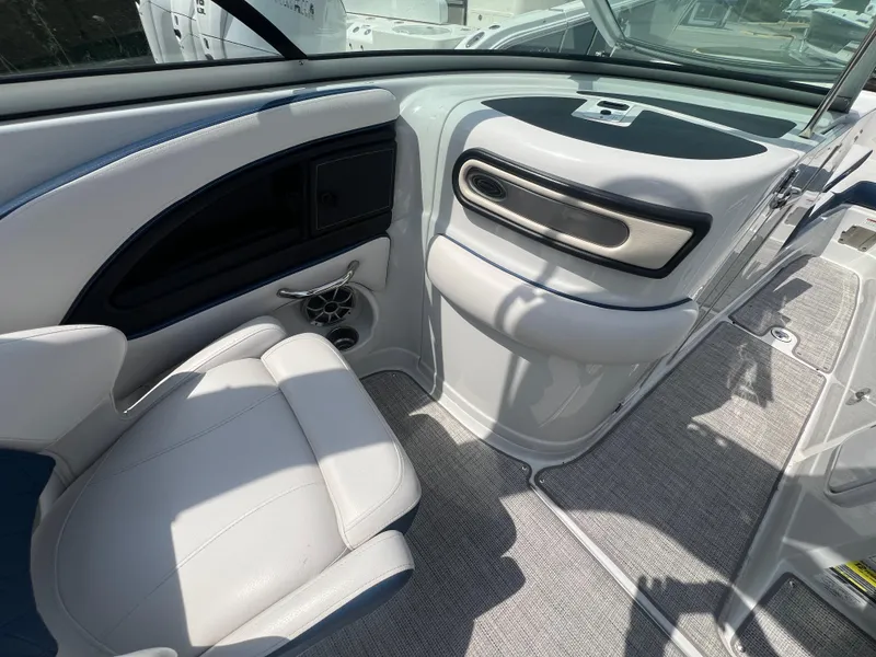 Slide: The Image of Interior of 2021 Crownline 255 SS boat with white seating and modern dashboard design. - 11