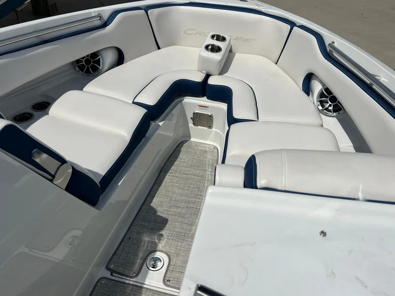 Slide: The Image of 2021 Crownline 255 SS boat interior with white seating and cup holders. - 6