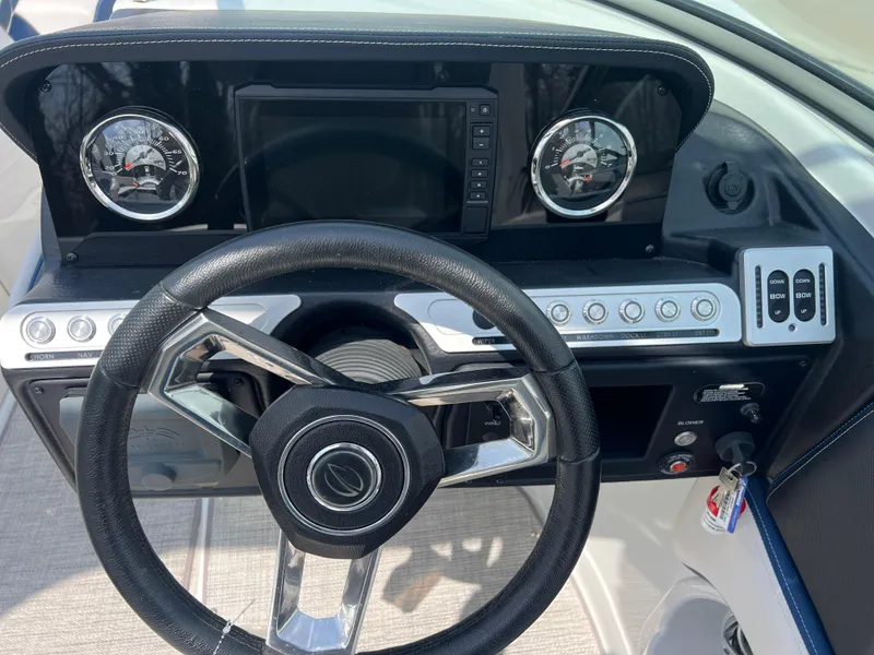Slide: The Image of Steering wheel and dashboard of 2021 Crownline 255 SS boat, featuring modern controls and gauges. - 9