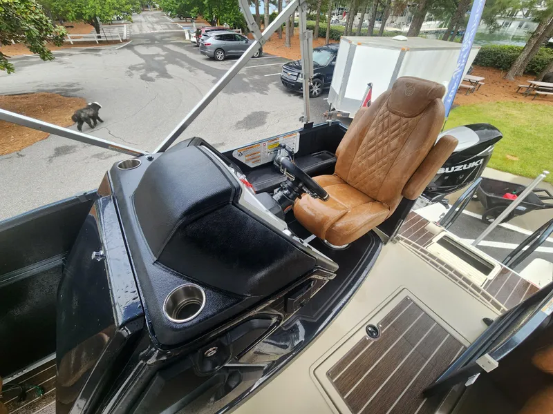 Slide: The Image of 2021 Premier 290 Grand View boat helm with leather seat and Suzuki engine. - 10