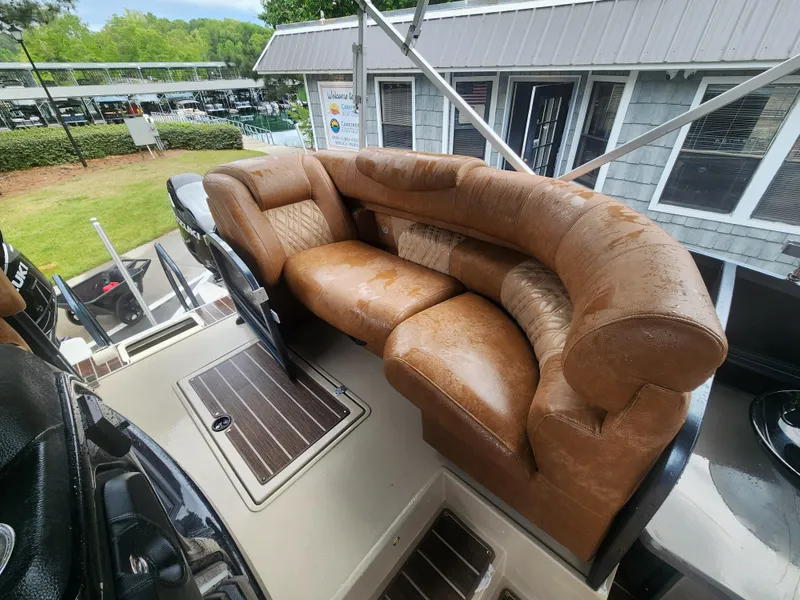 Slide: The Image of Luxurious brown seating on 2021 Premier 290 Grand View boat, docked near a building. - 12