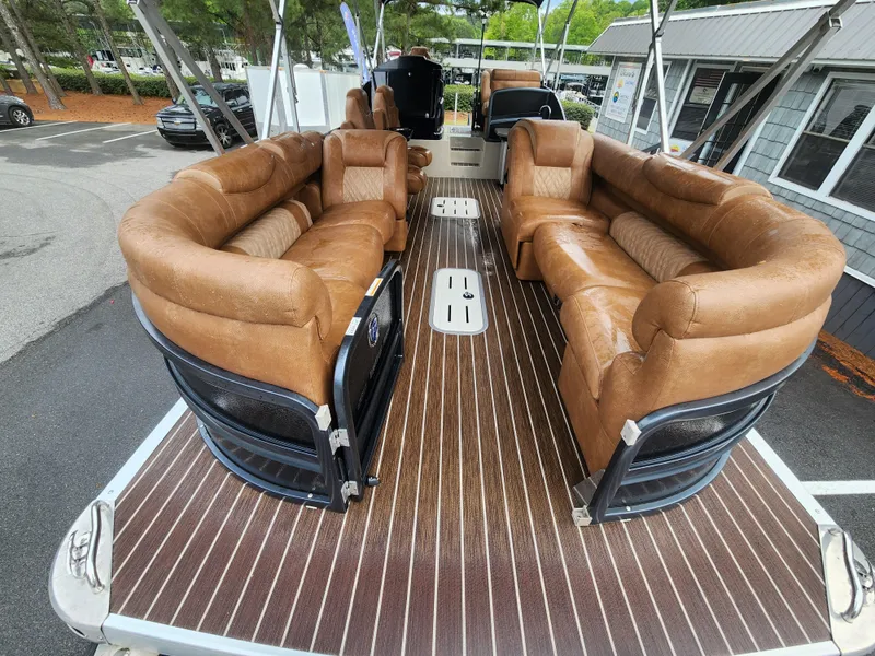 Slide: The Image of 2021 Premier 290 Grand View boat with luxurious brown seating and sleek wooden flooring. - 18