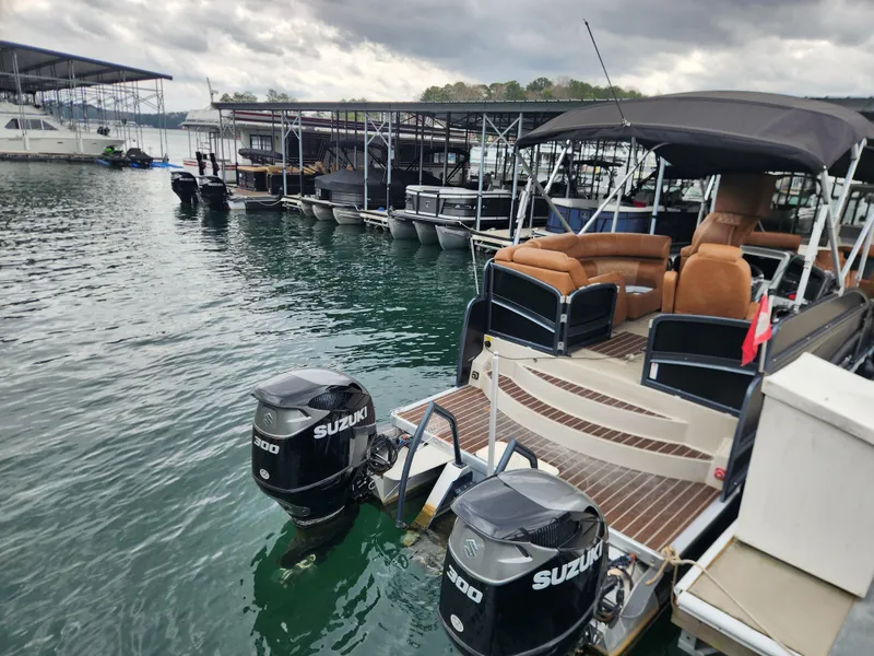 Slide: The Image of 2021 Premier 290 Grand View boat docked with dual Suzuki outboard motors. - 6