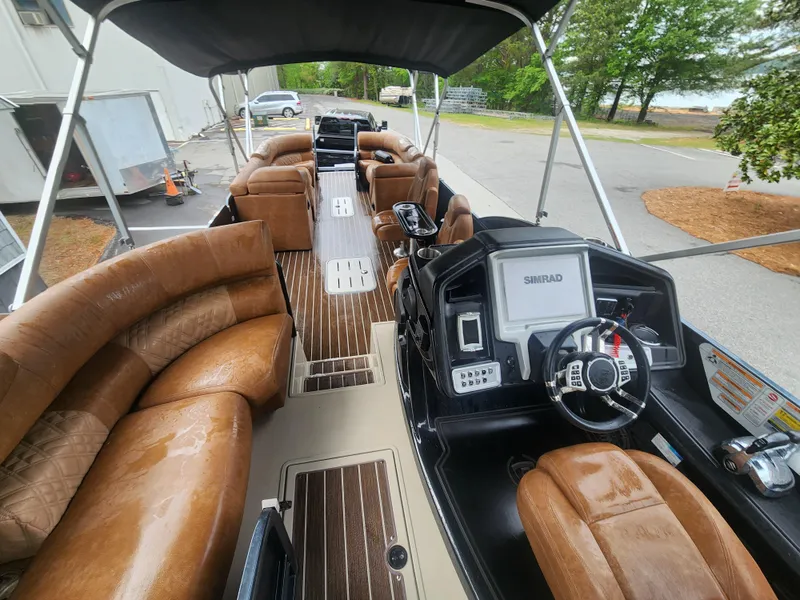 Slide: The Image of Luxurious 2021 Premier 290 Grand View pontoon boat with plush seating and modern dashboard. - 8