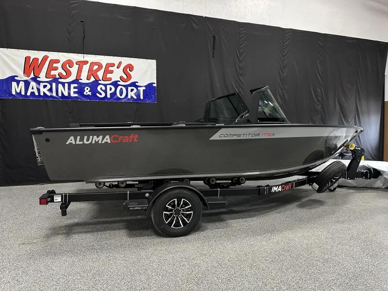 The Image of 2025 Alumacraft Competitor 175X Sport boat displayed indoors on a trailer. - 0