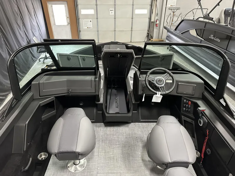 Slide: The Image of 2025 Alumacraft Competitor 175X Sport interior with dual seats and modern dashboard. - 11
