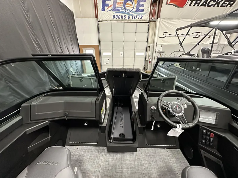 Slide: The Image of 2025 Alumacraft Competitor 175X Sport interior with steering wheel and dashboard in showroom. - 12