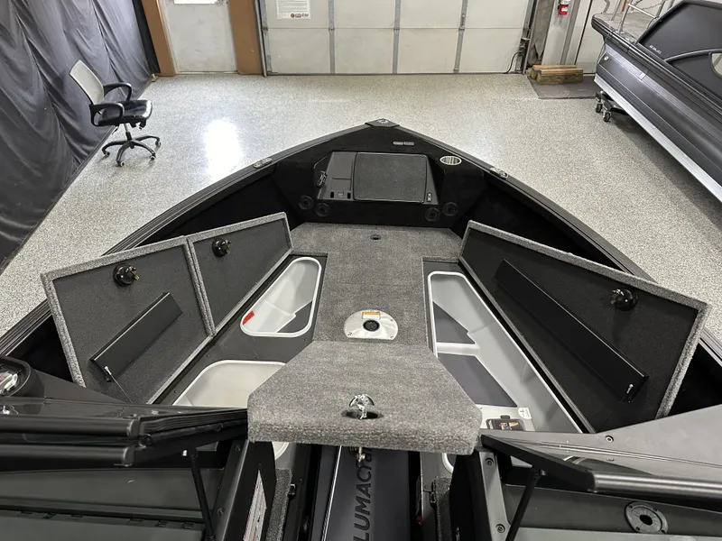 Slide: The Image of 2025 Alumacraft Competitor 175X Sport boat interior with open storage compartments. - 13