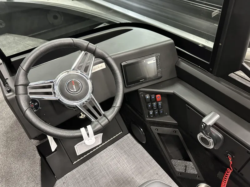 Slide: The Image of 2025 Alumacraft Competitor 175X Sport dashboard with steering wheel and control panel. - 17