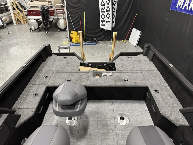 Slide: The Image of 2025 Alumacraft Competitor 175X Sport interior with gray seating and carpeted deck. - 18