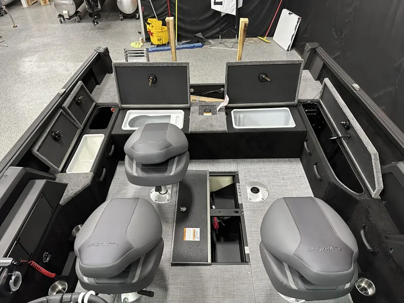Slide: The Image of 2025 Alumacraft Competitor 175X Sport interior with seating and storage compartments. - 19