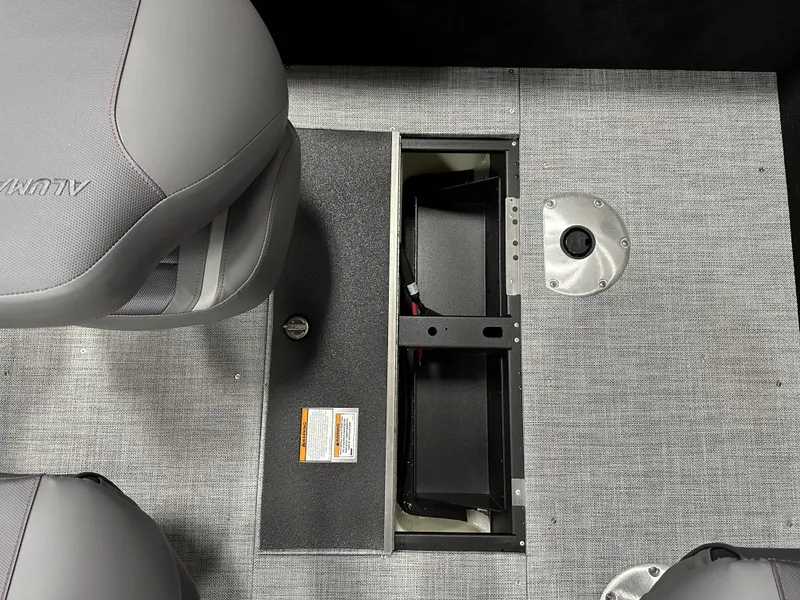 Slide: The Image of 2025 Alumacraft Competitor 175X Sport interior with open storage compartment and seating. - 20