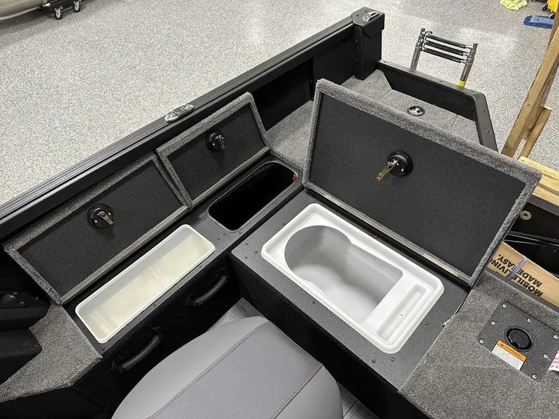 Slide: The Image of 2025 Alumacraft Competitor 175X Sport boat interior with storage compartments and seating. - 21