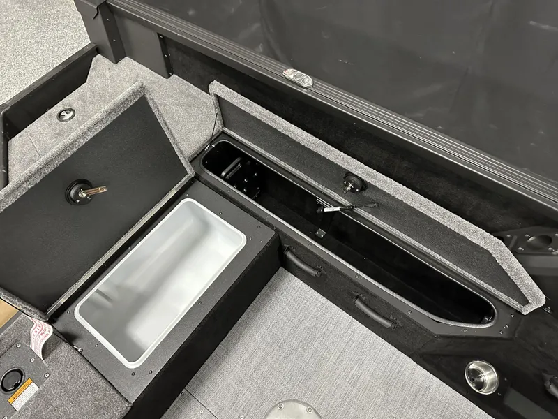 Slide: The Image of 2025 Alumacraft Competitor 175X Sport boat storage compartments with open lids, showcasing interior space. - 22