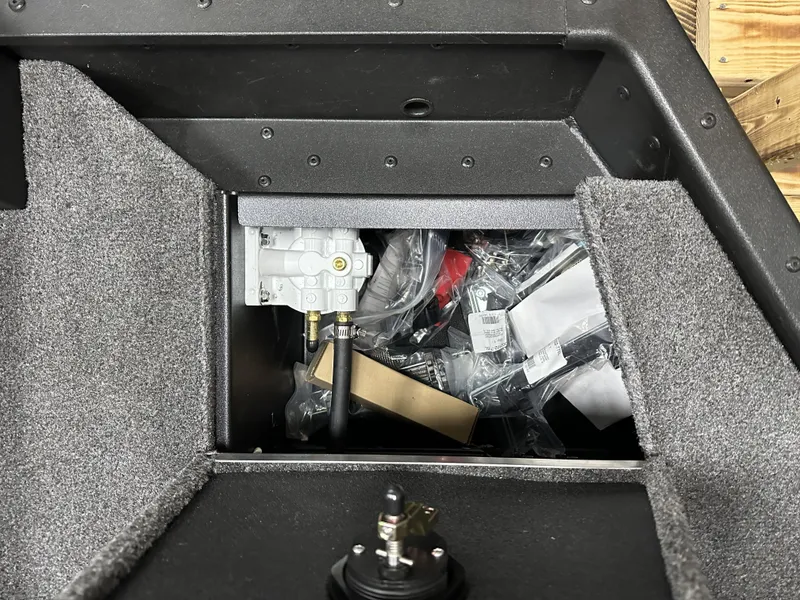 Slide: The Image of Interior storage compartment of 2025 Alumacraft Competitor 175X Sport boat, showing equipment and materials. - 24