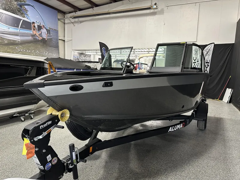 Slide: The Image of 2025 Alumacraft Competitor 175X Sport boat in showroom, rear view with trailer. - 4