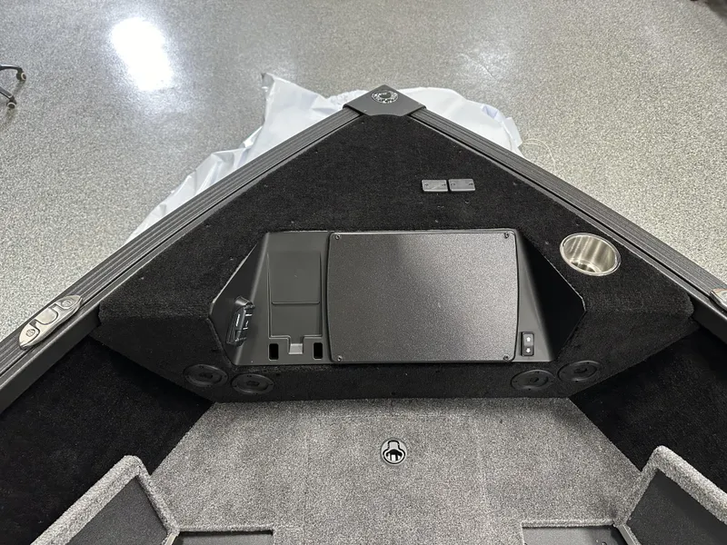 Slide: The Image of 2025 Alumacraft Competitor 175X Sport boat interior with storage and cup holder. - 6