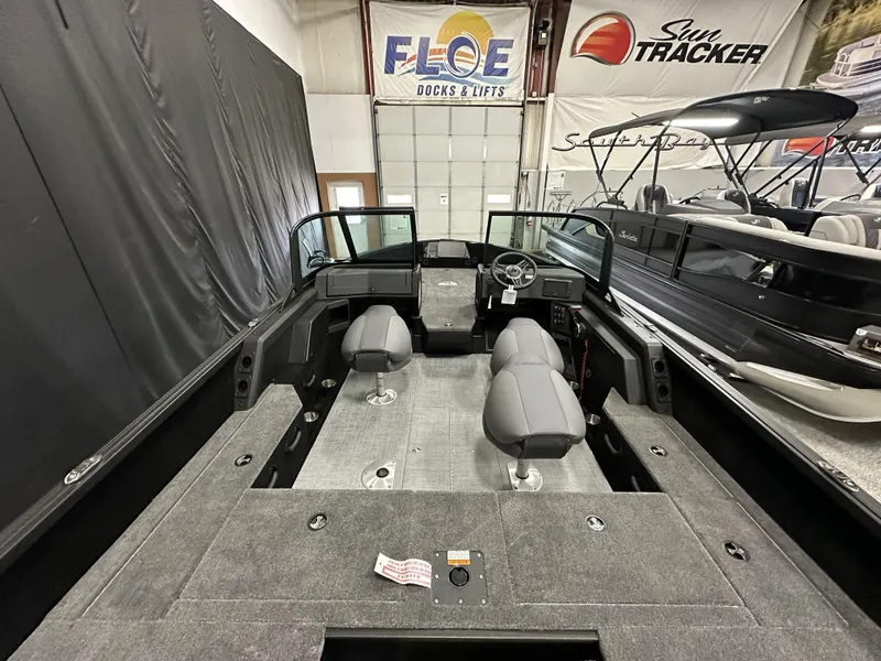 Slide: The Image of 2025 Alumacraft Competitor 175X Sport boat interior with gray seating and spacious layout. - 7