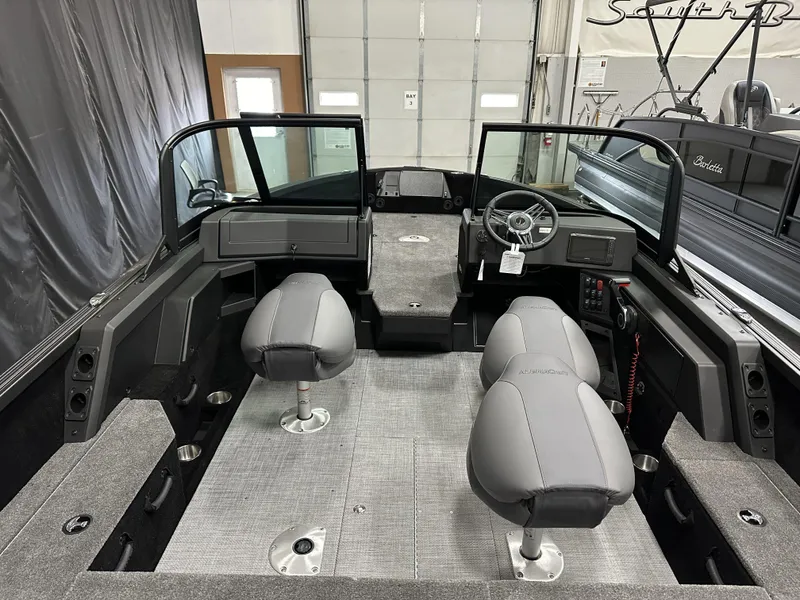 Slide: The Image of 2025 Alumacraft Competitor 175X Sport boat interior with gray seating and modern dashboard. - 8