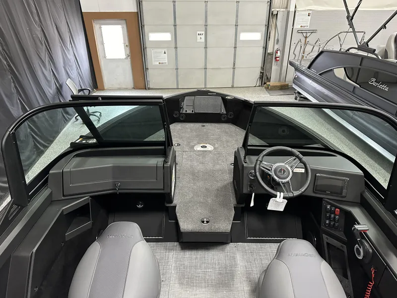 Slide: The Image of 2025 Alumacraft Competitor 175X Sport boat interior with steering wheel and seating. - 9