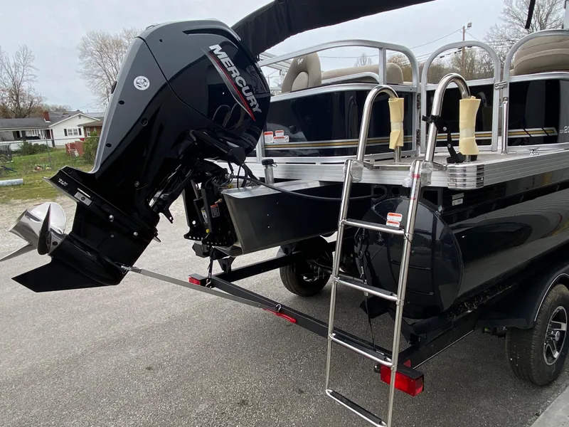 Slide: The Image of 2023 Ranger 200F boat with Mercury outboard motor and ladder, parked on a trailer. - 10