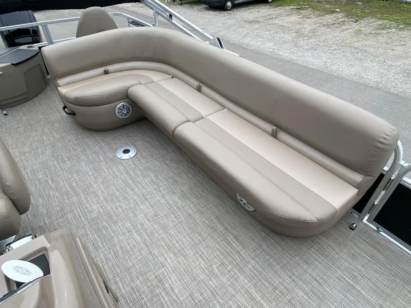 Slide: The Image of Spacious seating on 2023 Ranger 200F boat with beige upholstery and integrated speakers. - 7