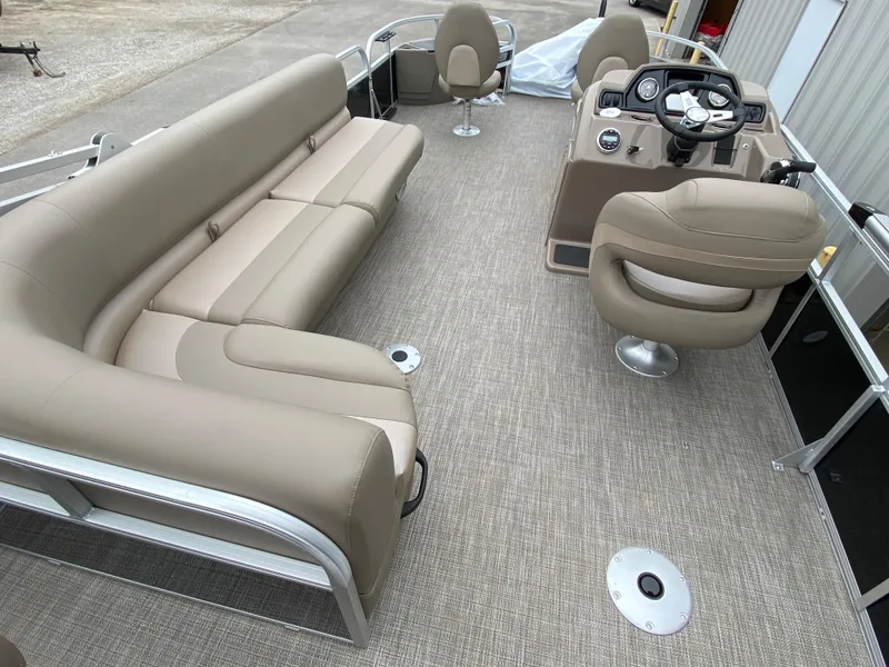 Slide: The Image of 2023 Ranger 200F pontoon boat interior with beige seating and modern dashboard. - 8