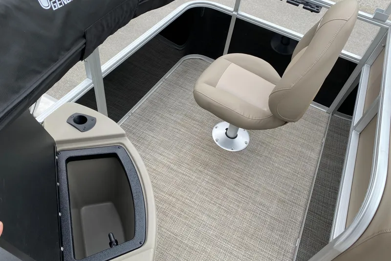 Slide: The Image of 2023 Ranger 200F boat interior with beige seating and storage compartment. - 9