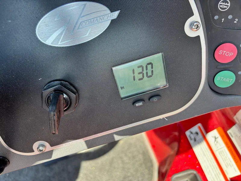 Slide: The Image of Dashboard of 2010 Ranger Z520 boat showing 130 hours on digital display. - 10