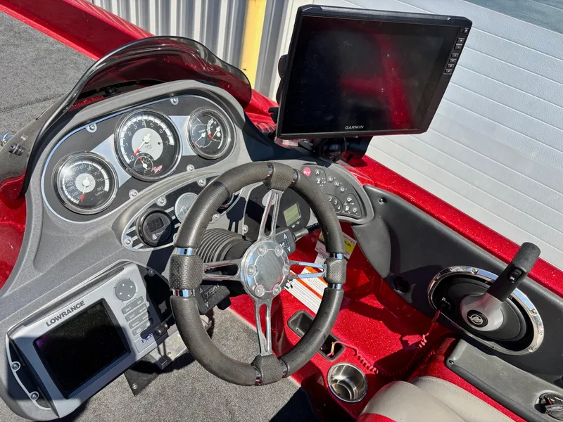 Slide: The Image of 2010 Ranger Z520 boat dashboard with steering wheel, gauges, and navigation screens. - 11