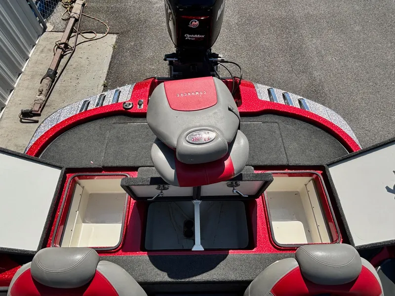 Slide: The Image of 2010 Ranger Z520 boat interior with red and gray seating, storage compartments, and motor. - 13