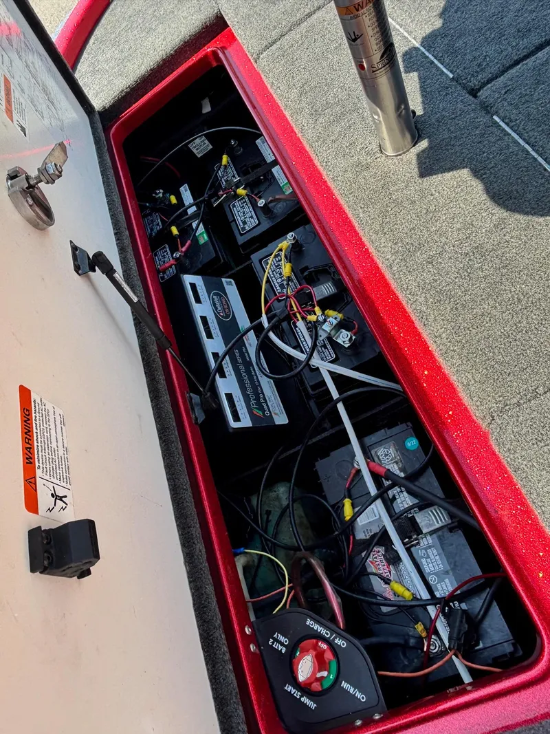 Slide: The Image of 2010 Ranger Z520 boat battery compartment with wiring and switches. - 14
