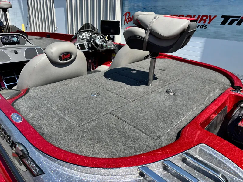 Slide: The Image of 2010 Ranger Z520 boat interior with gray seating and red accents. - 16