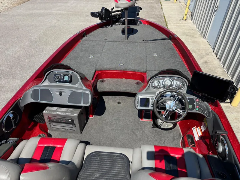 Slide: The Image of 2010 Ranger Z520 boat interior with steering wheel, dashboard, and seating. - 9