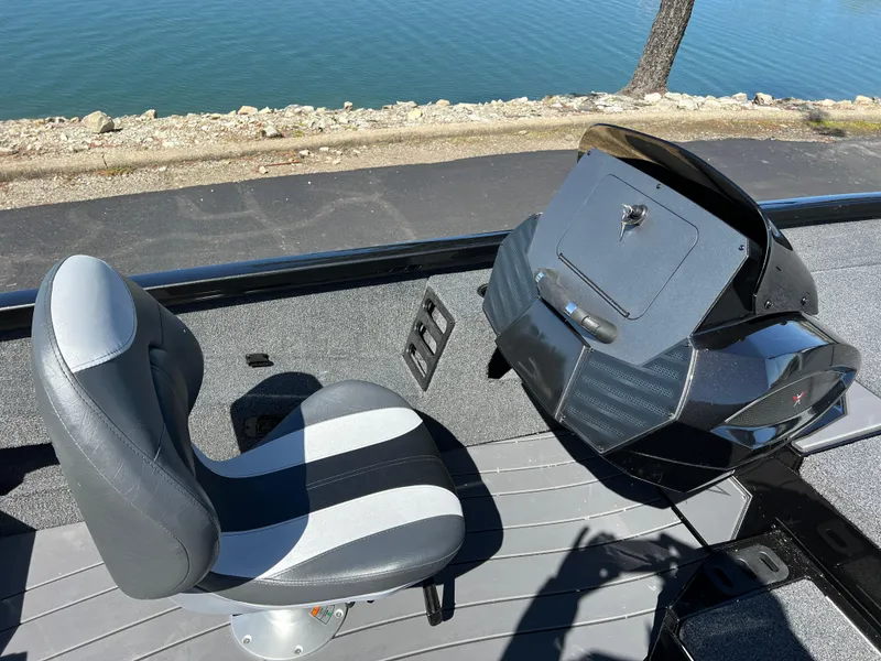 Slide: The Image of 2025 Vexus AVX1985S boat cockpit with seat and control panel by the water. - 13