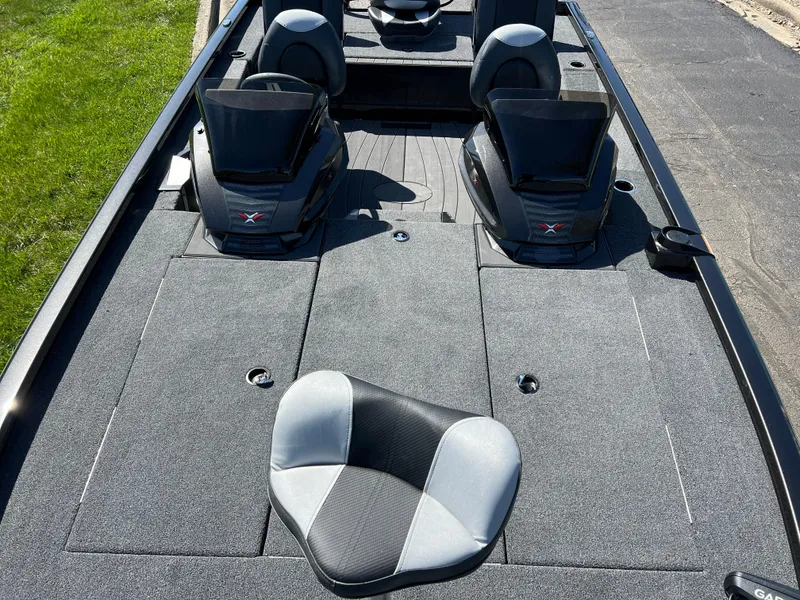 Slide: The Image of 2025 Vexus AVX1985S boat interior with gray seating and carpeted deck. - 18