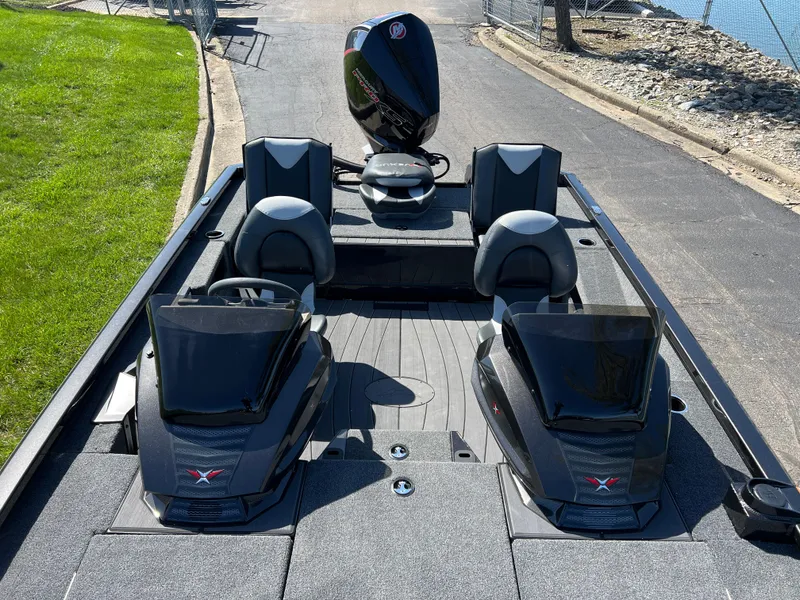 Slide: The Image of 2025 Vexus AVX1985S boat with dual consoles and seating, parked near a lakeside. - 19