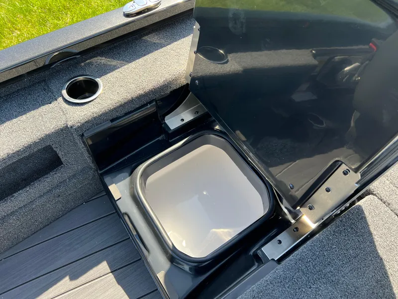 Slide: The Image of Open storage compartment in 2025 Vexus AVX1985S boat, featuring cup holder and sleek design. - 22
