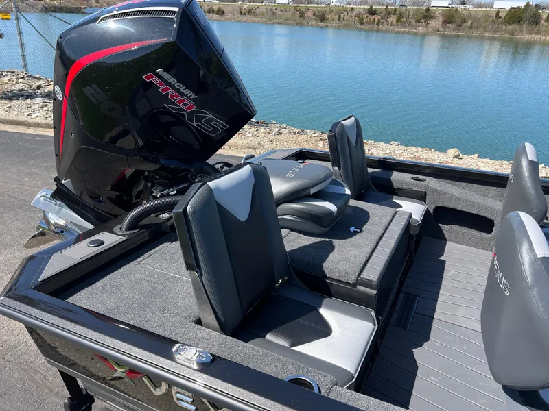 Slide: The Image of 2025 Vexus AVX1985S boat with sleek seating and powerful engine by a serene lake. - 7