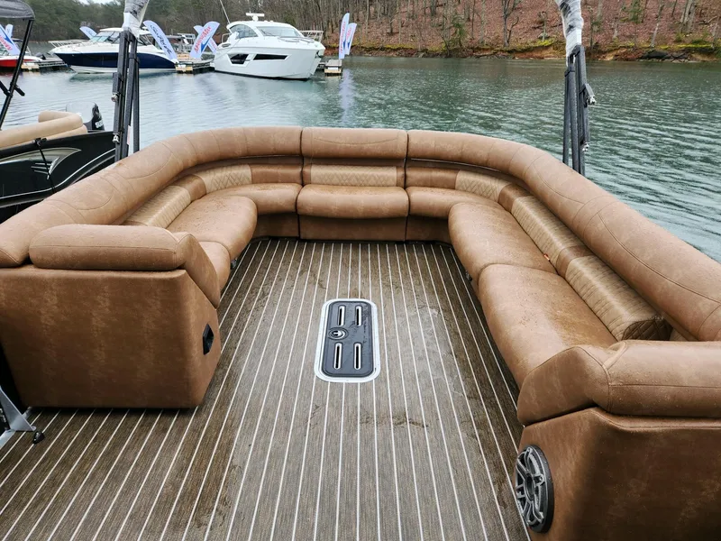 Slide: The Image of Luxurious 2023 Premier Escalante boat with spacious brown seating on a serene lake. - 3