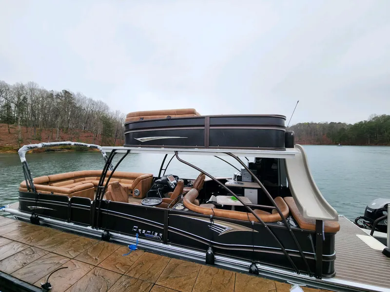 Slide: The Image of 2023 Premier Escalante pontoon boat docked on a serene lake. - 5