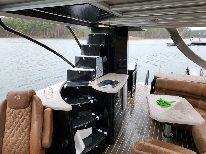 Slide: The Image of Luxurious 2023 Premier Escalante boat interior with leather seating and modern amenities on a lake. - 7