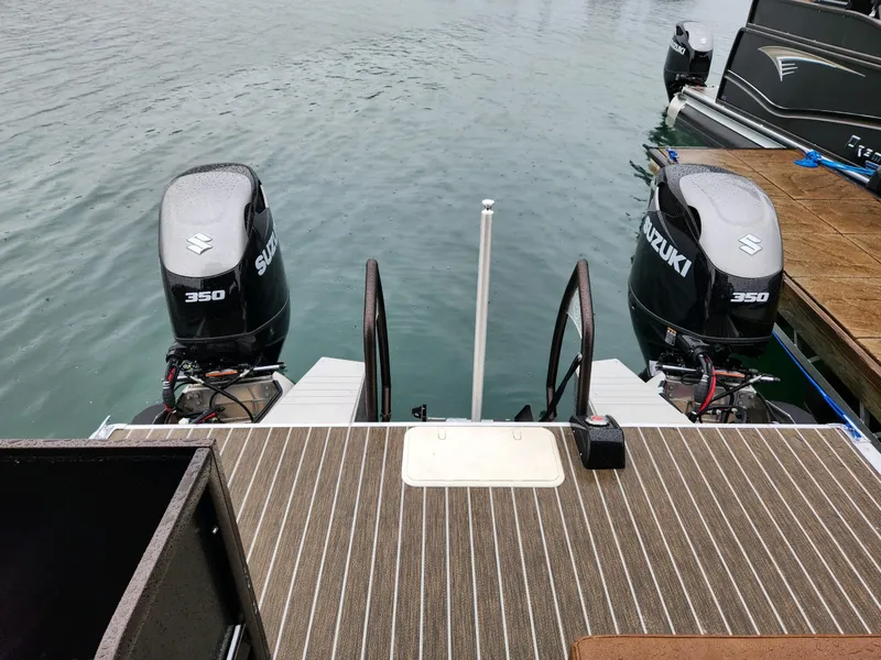 Slide: The Image of Twin Suzuki 350 outboard motors on a 2023 Premier Escalante boat at a dock. - 8